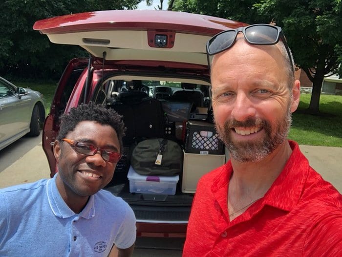 Fr. Laramie (right) with Fr. Armel Setubi, SJ, loading the red minivan.
